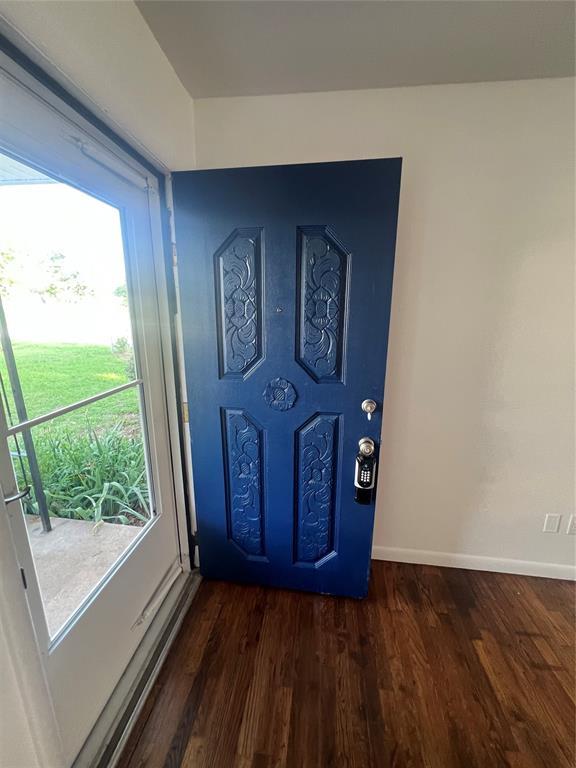 414 N 1st St, Tecumseh, OK 74873 - foyer entrance with dark wood-style flooring and baseboards