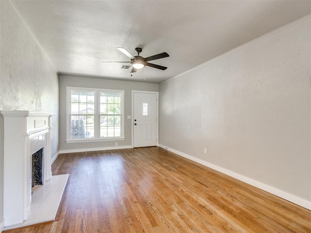 2748 Lancaster Ln, Oklahoma City, OK 73116 - unfurnished living room featuring wood finished floors, ceiling fan, baseboards, and a fireplace with raised hearth