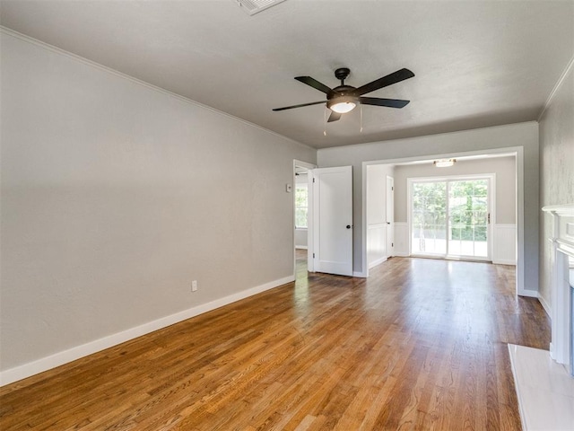 2748 Lancaster Ln, Oklahoma City, OK 73116 - unfurnished living room featuring light wood finished floors, a ceiling fan, ornamental molding, and baseboards