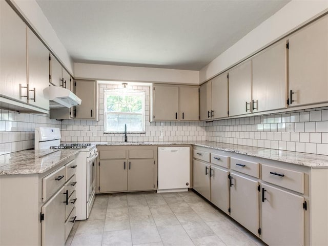 2748 Lancaster Ln, Oklahoma City, OK 73116 - kitchen featuring white appliances, a sink, under cabinet range hood, and backsplash