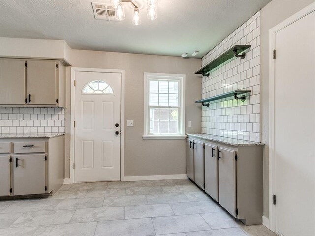 2748 Lancaster Ln, Oklahoma City, OK 73116 - kitchen with open shelves, backsplash, baseboards, and light tile patterned floors