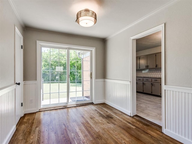 2748 Lancaster Ln, Oklahoma City, OK 73116 - empty room with wood finished floors, wainscoting, and crown molding