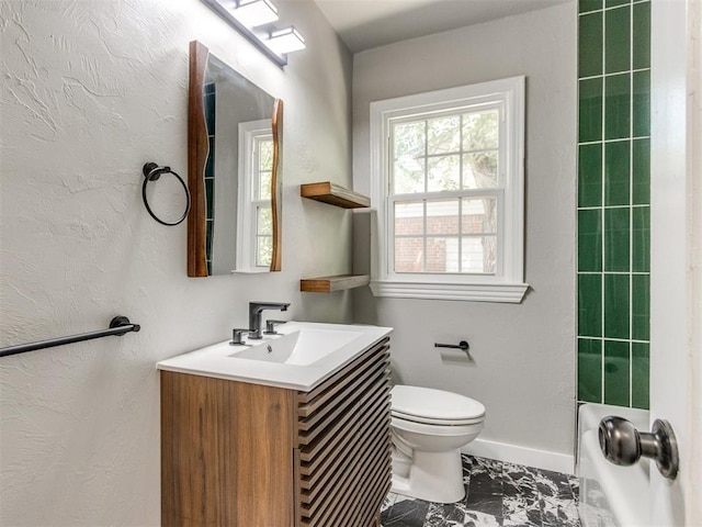 2748 Lancaster Ln, Oklahoma City, OK 73116 - full bath with vanity, marble look tile flooring, toilet, and baseboards