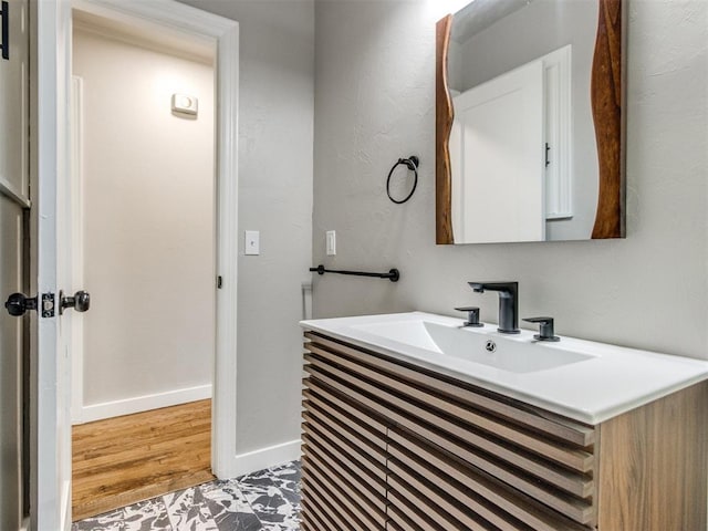 2748 Lancaster Ln, Oklahoma City, OK 73116 - bathroom with vanity, baseboards, and wood finished floors