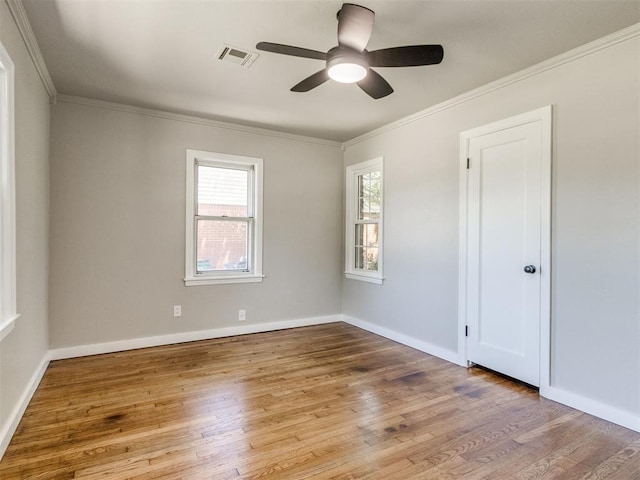 2748 Lancaster Ln, Oklahoma City, OK 73116 - spare room featuring ceiling fan, wood finished floors, crown molding, and baseboards