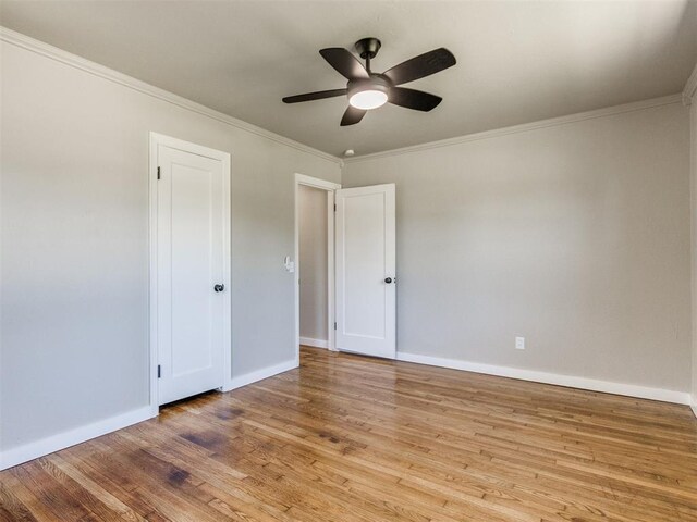 2748 Lancaster Ln, Oklahoma City, OK 73116 - unfurnished bedroom featuring wood finished floors, ornamental molding, baseboards, and ceiling fan