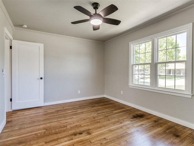 2748 Lancaster Ln, Oklahoma City, OK 73116 - empty room with ornamental molding, wood finished floors, baseboards, a ceiling fan, and a smoke detector