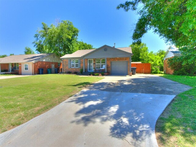 2748 Lancaster Ln, Oklahoma City, OK 73116 - single story home with driveway, a garage, a front lawn, and brick siding