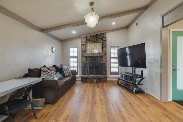 3501 Necia St, Moore, OK 73160 - living room featuring wood finished floors, a fireplace, a textured wall, and baseboards