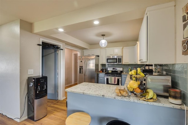 3501 Necia St, Moore, OK 73160 - kitchen featuring stainless steel appliances, a peninsula, tasteful backsplash, light wood-style flooring, and white cabinets