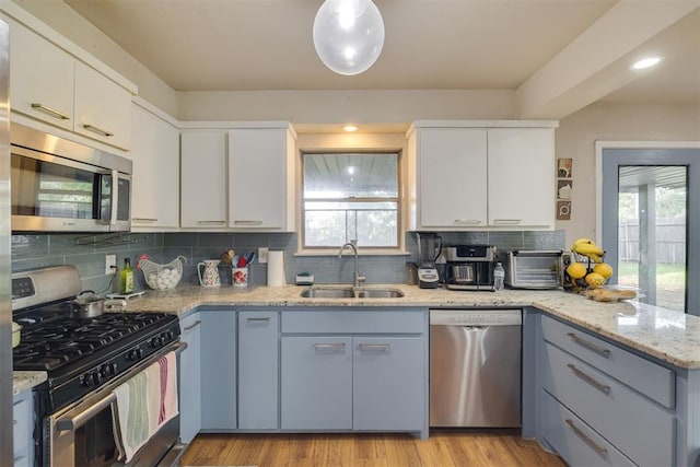3501 Necia St, Moore, OK 73160 - kitchen with appliances with stainless steel finishes, a sink, plenty of natural light, and tasteful backsplash