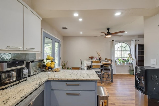 3501 Necia St, Moore, OK 73160 - kitchen featuring a peninsula, light wood-style flooring, recessed lighting, white cabinetry, and a ceiling fan