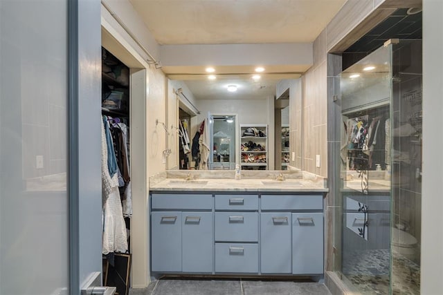 3501 Necia St, Moore, OK 73160 - bathroom featuring a spacious closet, a stall shower, and double vanity
