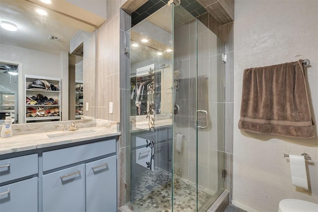 3501 Necia St, Moore, OK 73160 - full bath featuring a shower stall, a walk in closet, vanity, and toilet