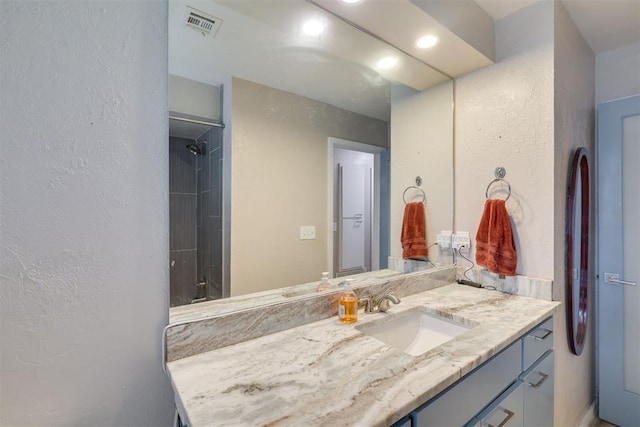 3501 Necia St, Moore, OK 73160 - bathroom with a textured wall, recessed lighting, and vanity