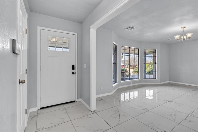 8116 NW 82nd St, Oklahoma City, OK 73132 - foyer entrance with light marble finish floors, baseboards, and a chandelier