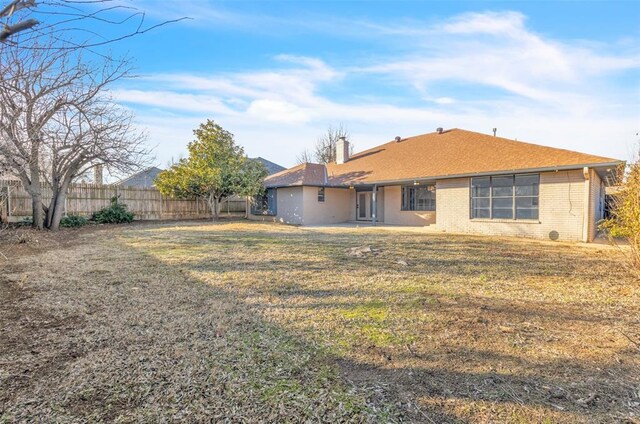 8116 NW 82nd St, Oklahoma City, OK 73132 - rear view of property featuring a chimney and brick siding