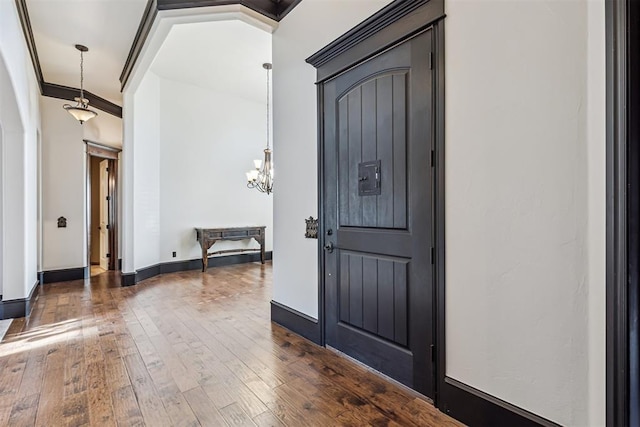 3101 Monica Ln, Moore, OK 73160 - entryway featuring hardwood / wood-style floors, a chandelier, and crown molding