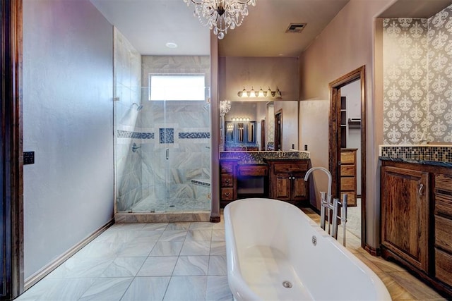 3101 Monica Ln, Moore, OK 73160 - full bathroom with a chandelier, vanity, a stall shower, and a freestanding bath