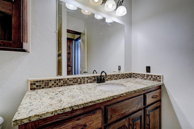 3101 Monica Ln, Moore, OK 73160 - bathroom featuring backsplash, vanity, and a textured wall