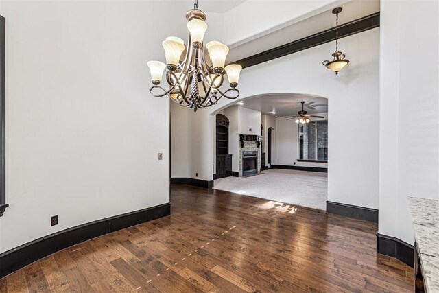 3101 Monica Ln, Moore, OK 73160 - spare room with arched walkways, a ceiling fan, hardwood / wood-style flooring, a chandelier, and a fireplace