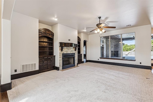 3101 Monica Ln, Moore, OK 73160 - unfurnished living room featuring a ceiling fan, a fireplace, carpet, and arched walkways