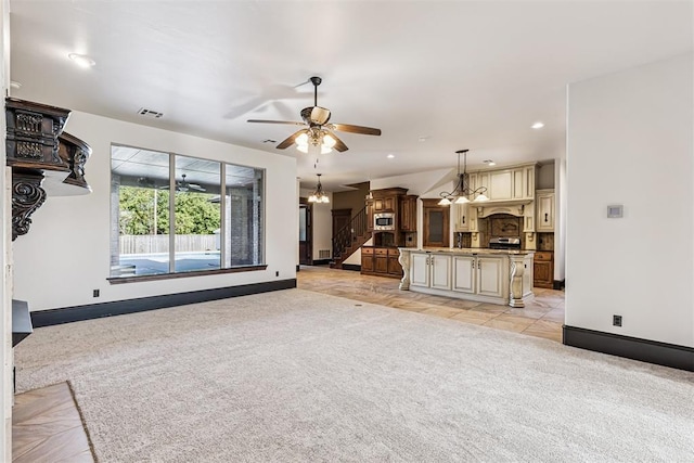 3101 Monica Ln, Moore, OK 73160 - unfurnished living room featuring light colored carpet, stairs, a ceiling fan, recessed lighting, and a chandelier
