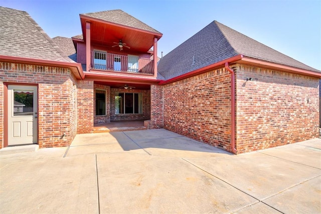 3101 Monica Ln, Moore, OK 73160 - back of property with a balcony, ceiling fan, brick siding, and a shingled roof