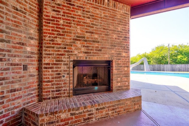 3101 Monica Ln, Moore, OK 73160 - detailed view of brick siding, an outdoor brick fireplace, and a swimming pool