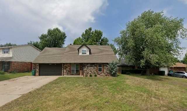 8813 Aaron Dr, Oklahoma City, OK 73132 - view of front of house with an attached garage, a front lawn, and concrete driveway