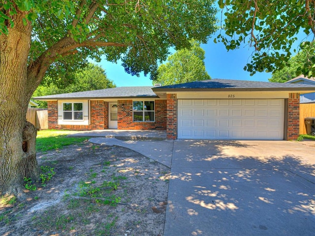 825 N Robinson Ave, Moore, OK 73170 - ranch-style home featuring a garage, concrete driveway, and brick siding