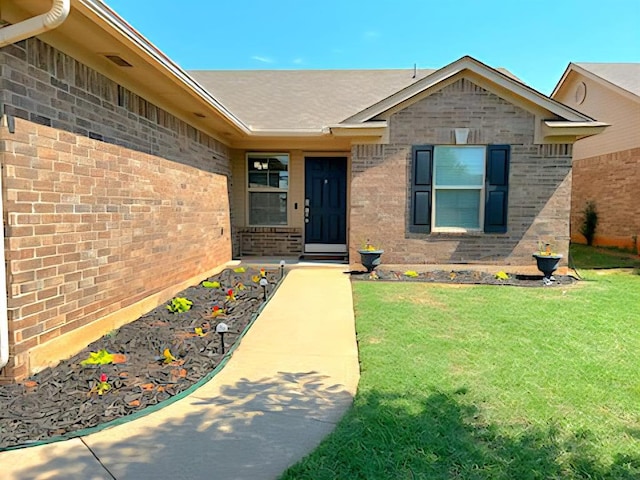 9525 SW 27th St, Oklahoma City, OK 73128 - doorway to property with a lawn and brick siding
