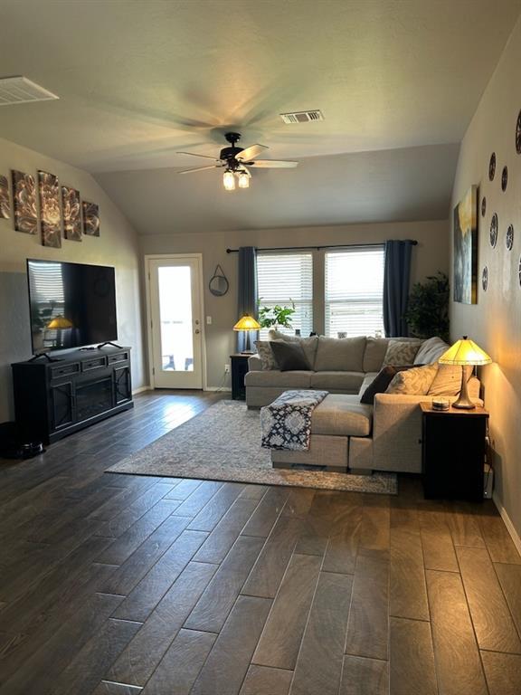 9525 SW 27th St, Oklahoma City, OK 73128 - living room with lofted ceiling, a ceiling fan, dark wood-type flooring, and baseboards