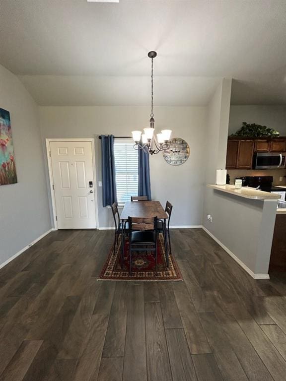 9525 SW 27th St, Oklahoma City, OK 73128 - dining area featuring a chandelier, dark wood-style flooring, baseboards, and lofted ceiling
