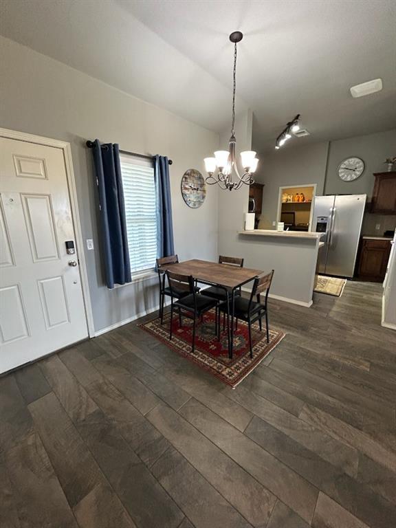 9525 SW 27th St, Oklahoma City, OK 73128 - dining space featuring a chandelier, dark wood-style flooring, and baseboards