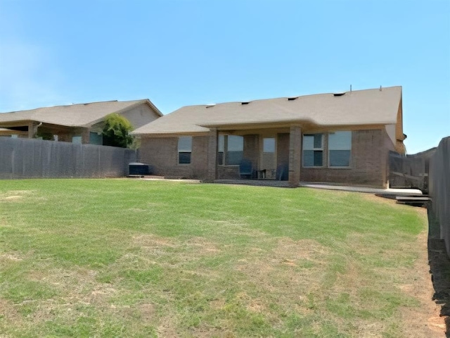 9525 SW 27th St, Oklahoma City, OK 73128 - back of house featuring central air condition unit and brick siding