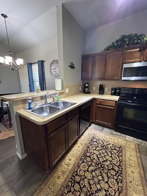 9525 SW 27th St, Oklahoma City, OK 73128 - kitchen with black appliances, a sink, a peninsula, a chandelier, and light countertops