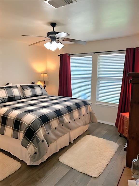 9525 SW 27th St, Oklahoma City, OK 73128 - bedroom with wood finished floors, ceiling fan, and baseboards