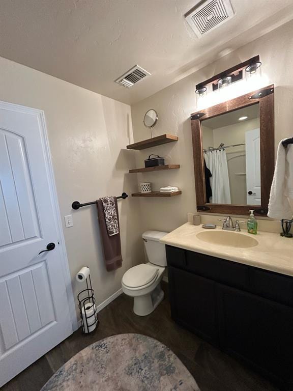9525 SW 27th St, Oklahoma City, OK 73128 - full bath featuring vanity, toilet, and wood finished floors