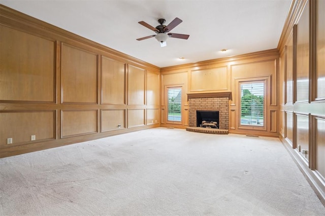 8 Brentwood Pl, Shawnee, OK 74804 - unfurnished living room with a decorative wall, healthy amount of natural light, a brick fireplace, ceiling fan, and light carpet