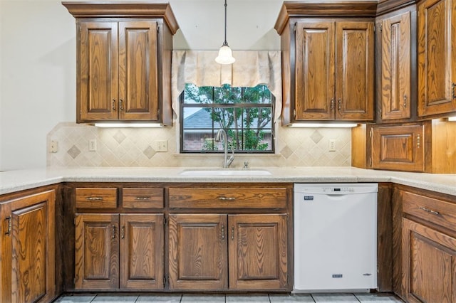 8 Brentwood Pl, Shawnee, OK 74804 - kitchen with white dishwasher, a sink, decorative light fixtures, light countertops, and backsplash