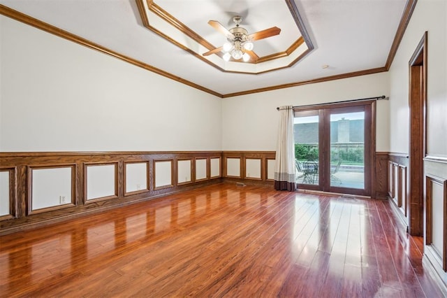 8 Brentwood Pl, Shawnee, OK 74804 - spare room featuring wood finished floors, a ceiling fan, a wainscoted wall, crown molding, and a raised ceiling