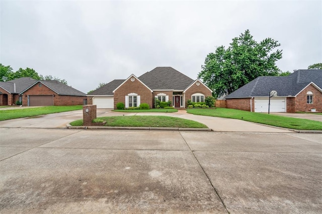 8 Brentwood Pl, Shawnee, OK 74804 - traditional-style home featuring concrete driveway, brick siding, and a front lawn