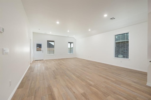 2836 NW 28th St, Yukon, OK 73099 - unfurnished living room with light wood-style flooring, baseboards, recessed lighting, and lofted ceiling
