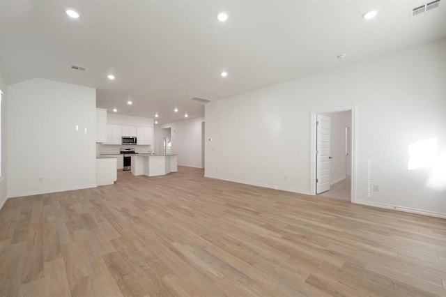 2836 NW 28th St, Yukon, OK 73099 - unfurnished living room featuring light wood-style floors, baseboards, and recessed lighting