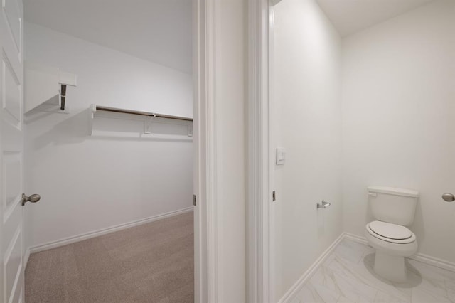 2836 NW 28th St, Yukon, OK 73099 - bathroom with toilet, marble finish flooring, and baseboards
