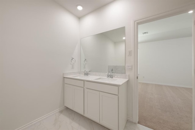 2836 NW 28th St, Yukon, OK 73099 - bathroom with baseboards, double vanity, marble look tiles, and recessed lighting