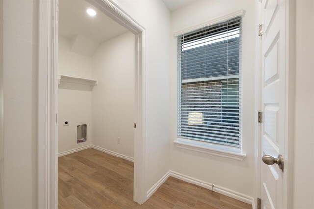2836 NW 28th St, Yukon, OK 73099 - laundry room with light wood-style floors, baseboards, electric dryer hookup, and healthy amount of natural light