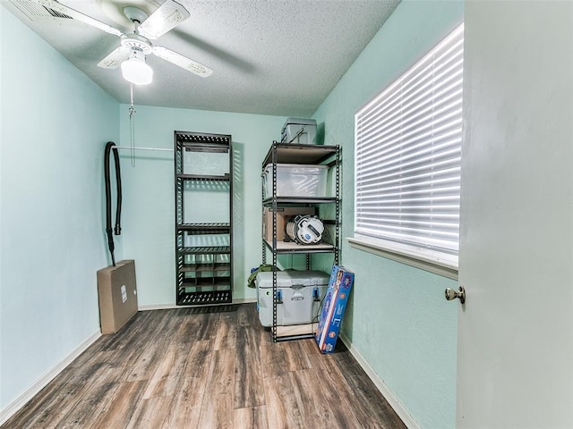 1202 N 8th Ave, Purcell, OK 73080 - bedroom with wood finished floors, a textured ceiling, baseboards, and ceiling fan