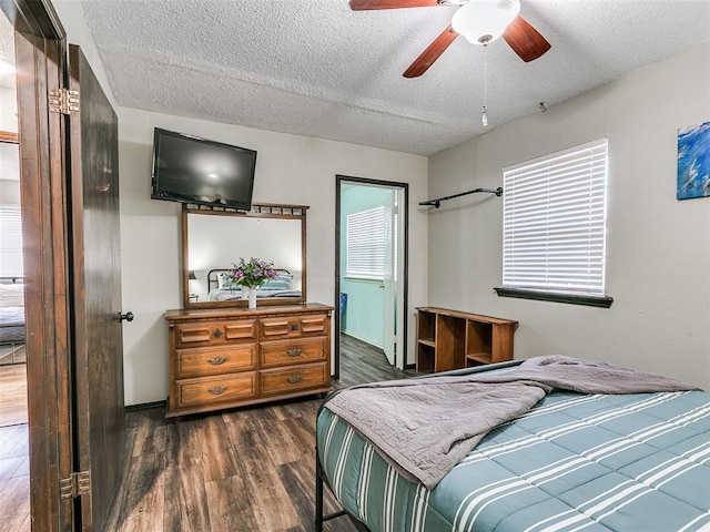 1202 N 8th Ave, Purcell, OK 73080 - bedroom with a textured ceiling, dark wood-style floors, and ceiling fan